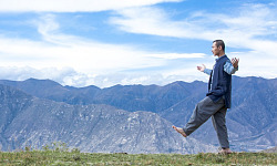 a man walking with arms wide open in a balanced pose