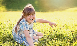 radiant young girl in an equally radiant meadow