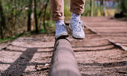 showing the feet and legs of someone balancing on one foot