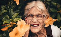 Elderly woman with bright smile symbolizing super aging and cognitive health