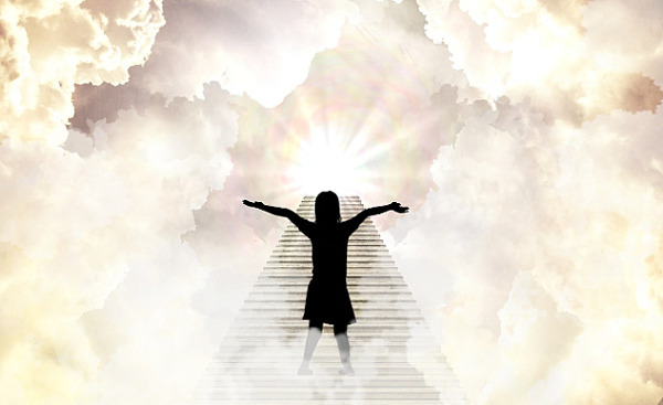 a person with arms wide open standing on a staircase in the clouds