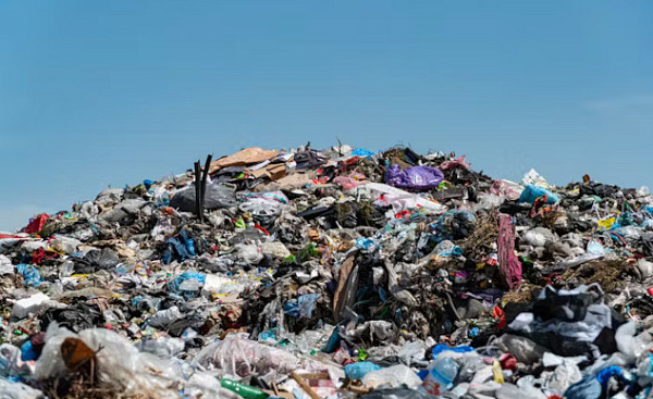 Suggested Alt Image Text:  A degraded landfill leaking into nearby soil and water, illustrating the ongoing threat of PCB pollution to the environment.