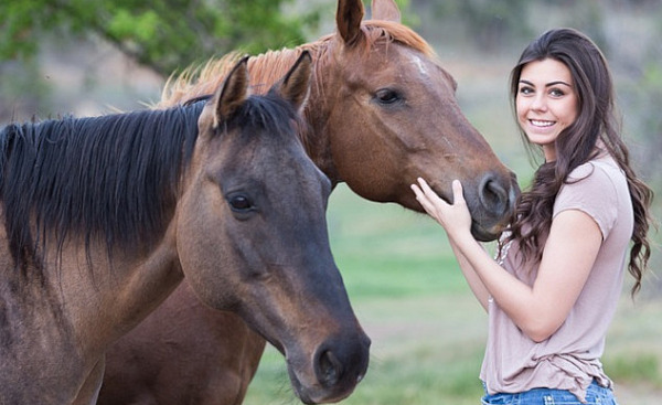 a young woman with two horses