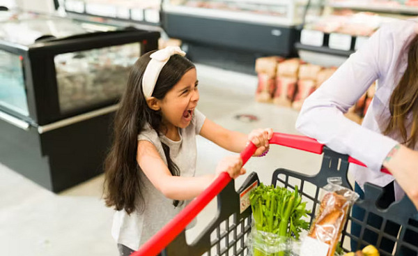 A child reacting strongly to sensory stimuli, highlighting challenges of sensory processing disorder, such as sensitivity to textures and sounds.