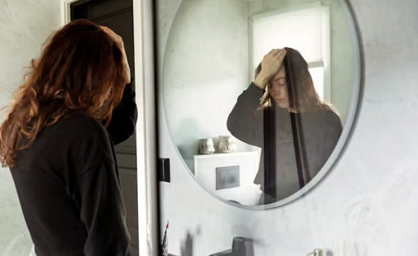 a person looking at themselves in the mirror