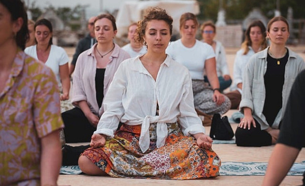 a group of women sitting together and meditating