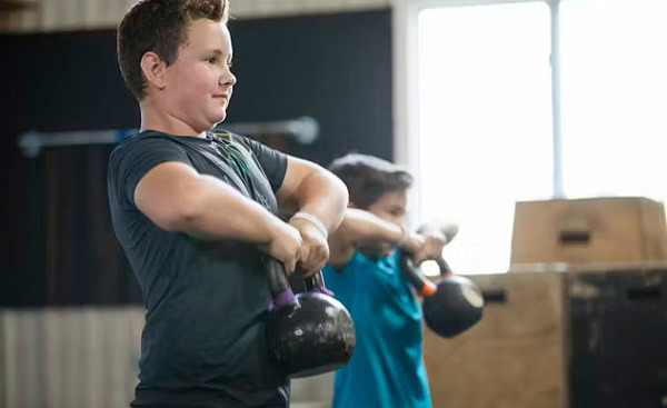 Children and teens engaged in strength training.