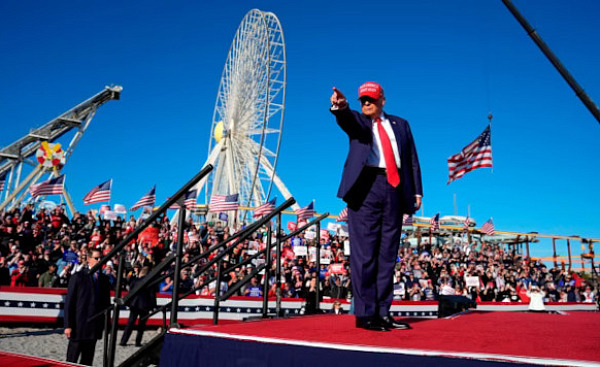 An image of Trump addressing crowds, symbolizing the rise of authoritarianism fueled by bigotry and racism.