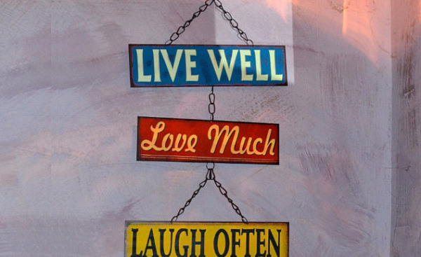 a sign that says: Live Well, Love Much, Laugh Often