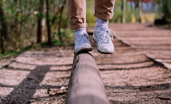 showing the feet and legs of someone balancing on one foot