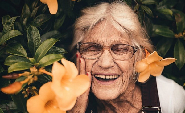 Elderly woman with bright smile symbolizing super aging and cognitive health