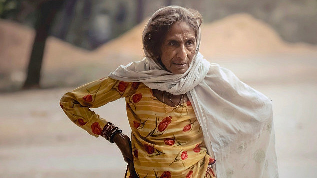 an older woman standing outside with a very determined expression