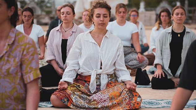 a group of women sitting together and meditating