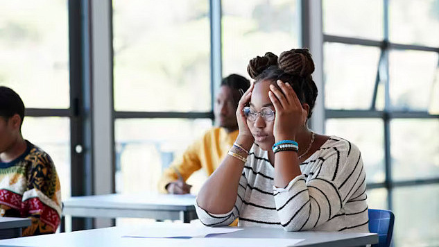 A stressed college student representing the challenge of time poverty in higher education.