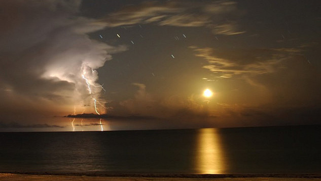 moon setting over the Gulf of Mexico illuminating clouds, sky, and water