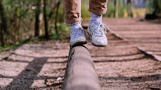 showing the feet and legs of someone balancing on one foot