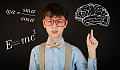 young boy in front of a blackboard