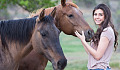 a young woman with two horses