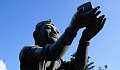 buddha statue holding up a gift to the heavens