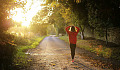 girl walking on a country road toward a bright light in the distance