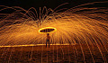 a person holding an umbrella under fireworks