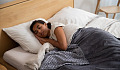 a woman laying in bed sleeping