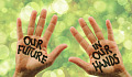 photo of two open hands with the words painted on them: Our Future in Our Hands