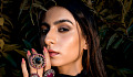 a woman wearing multiple gemstone rings on her fingers