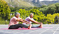 people doing stretching exercises outside