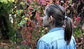 young woman looking out at some trees