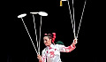 a woman balancing a series of plates on sticks