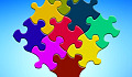 brightly multi-colored puzzle pieces joined together